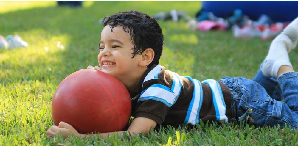Nick playing in the grass with a ball